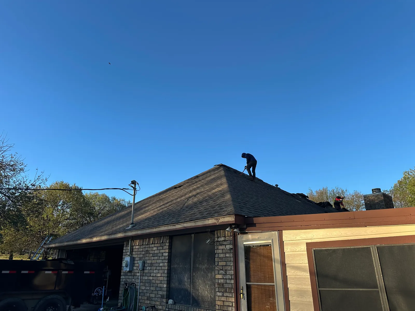 Side view of the existing shingles being removed from the Denison home.