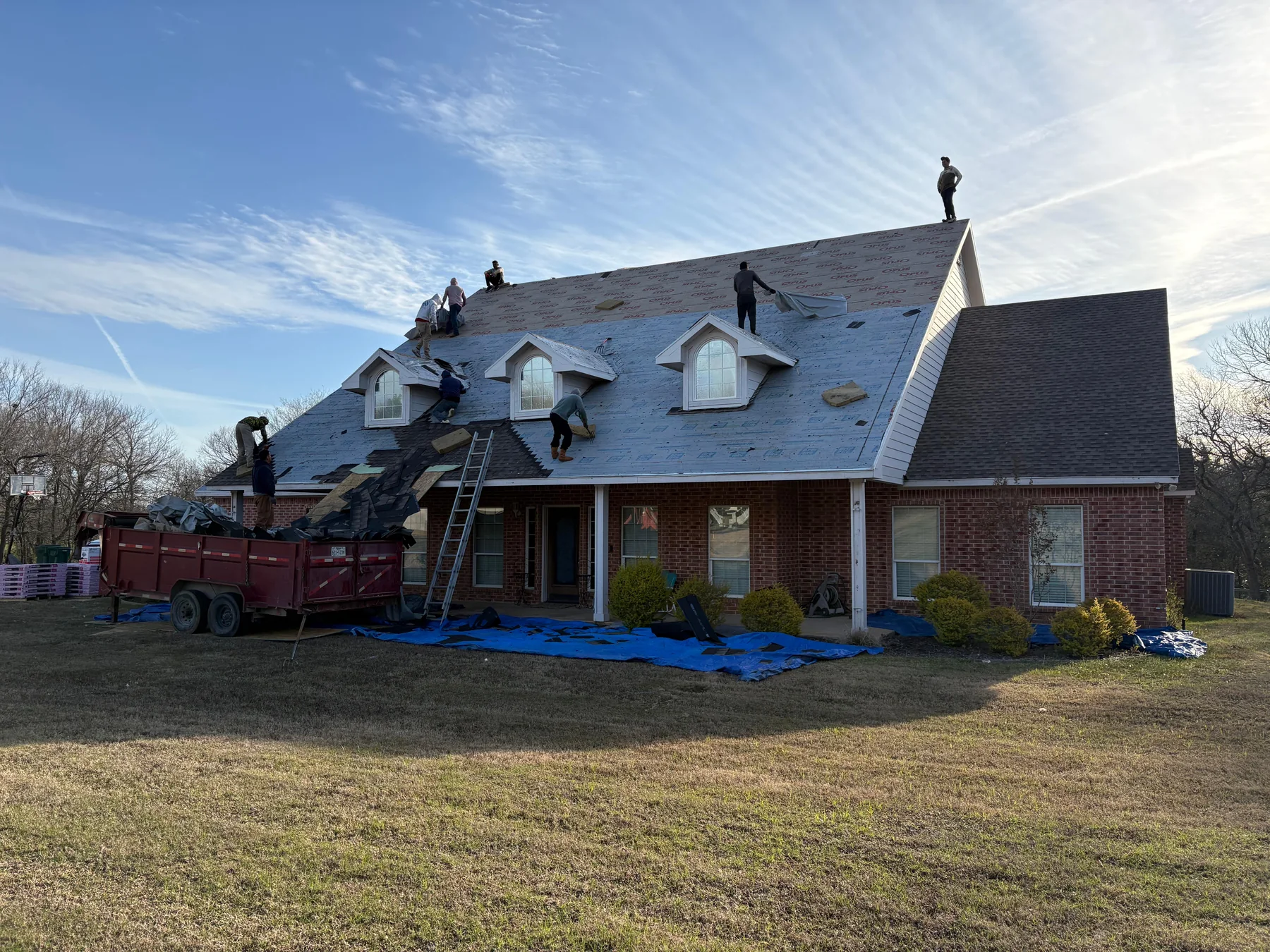 Roof tear-off in progress on a hail-damaged Denison Texas home