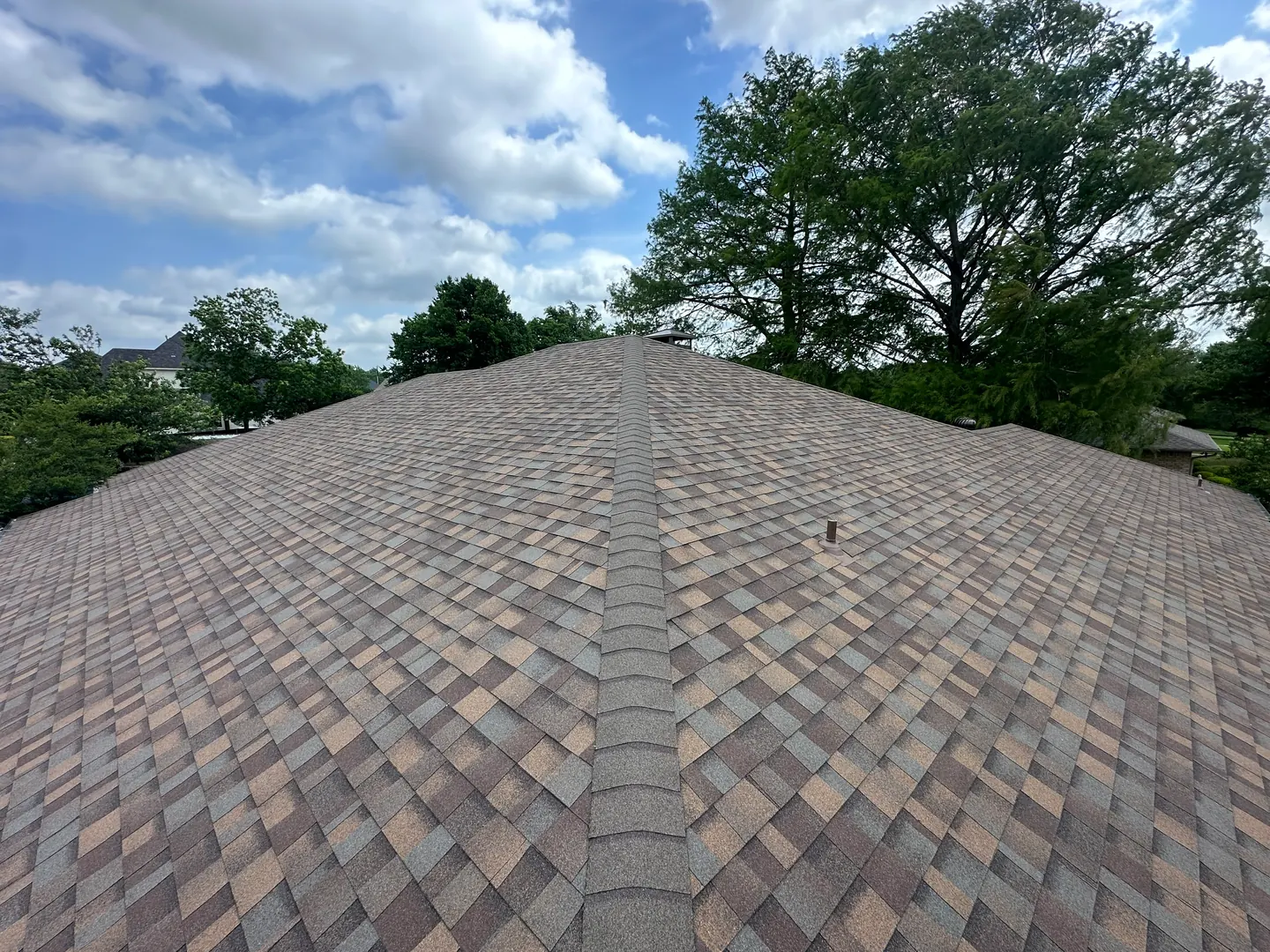 Completed Teak shingles across the hips and slopes of the Denison roof.