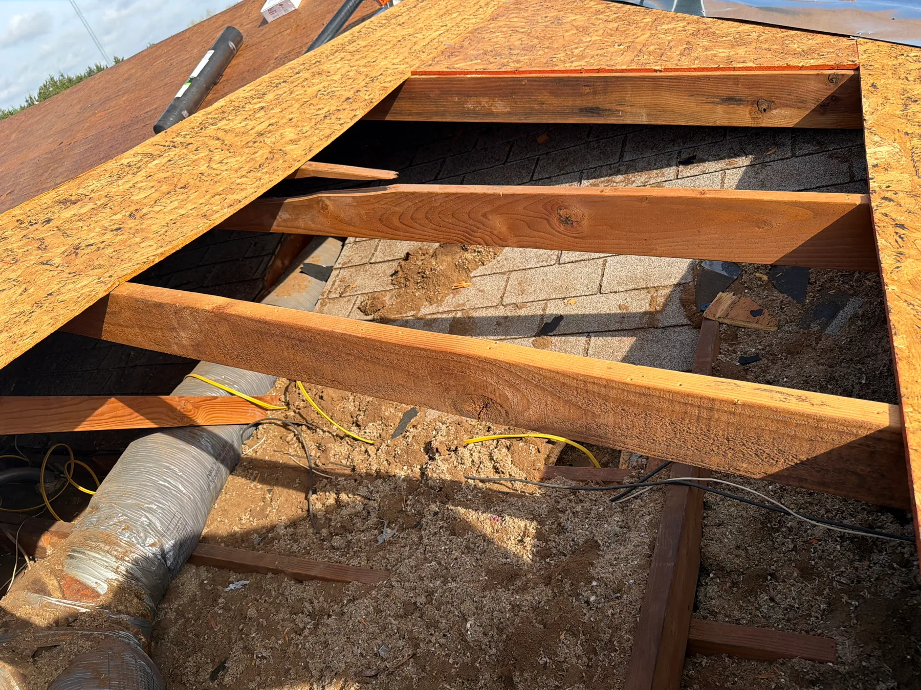 Broken rafters and rotten roof decking exposed during a Pottsboro Texas roof replacement