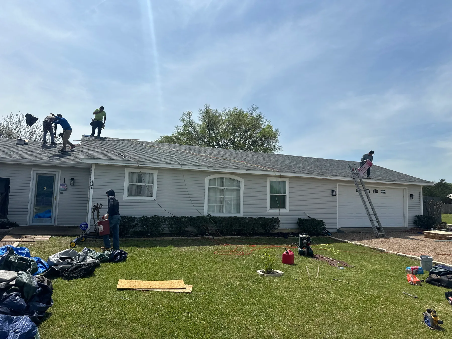 Roofing crew installing shingles during the documented Pottsboro, TX roof replacement