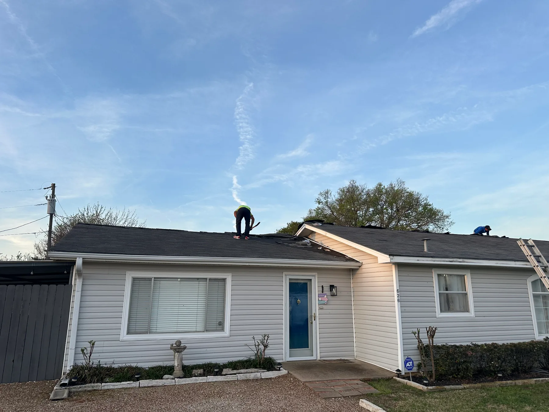 Existing shingles being removed during a Pottsboro Texas hail-damage reroof