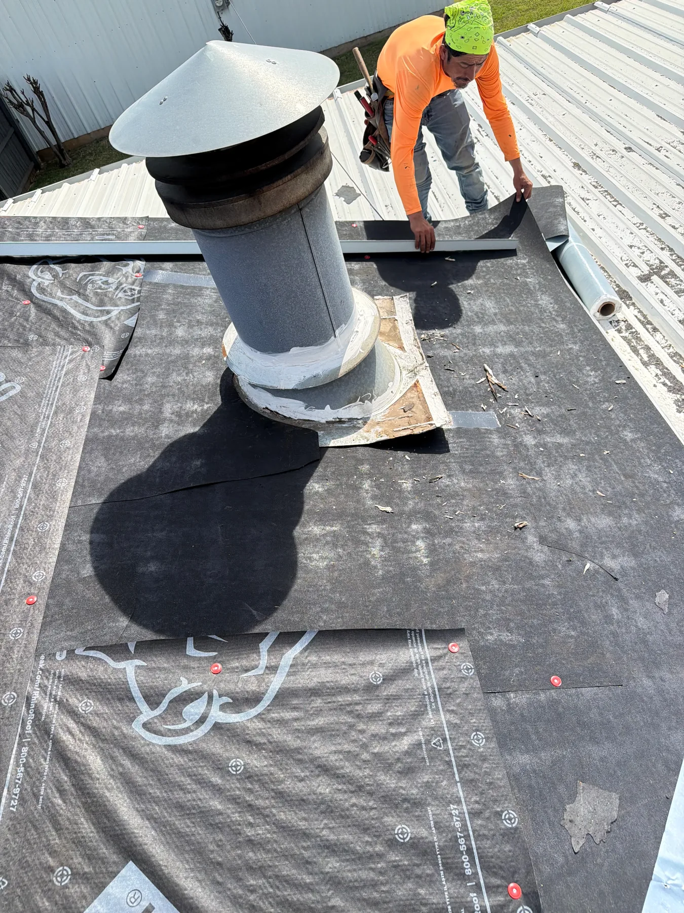 Roof underlayment and chimney flashing protection being installed in Pottsboro Texas
