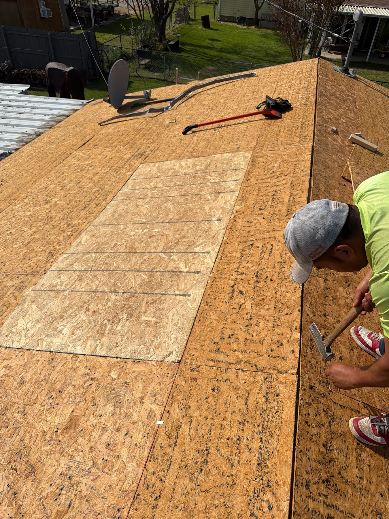 Damaged roof decking being replaced during a Pottsboro Texas hail-damage reroof