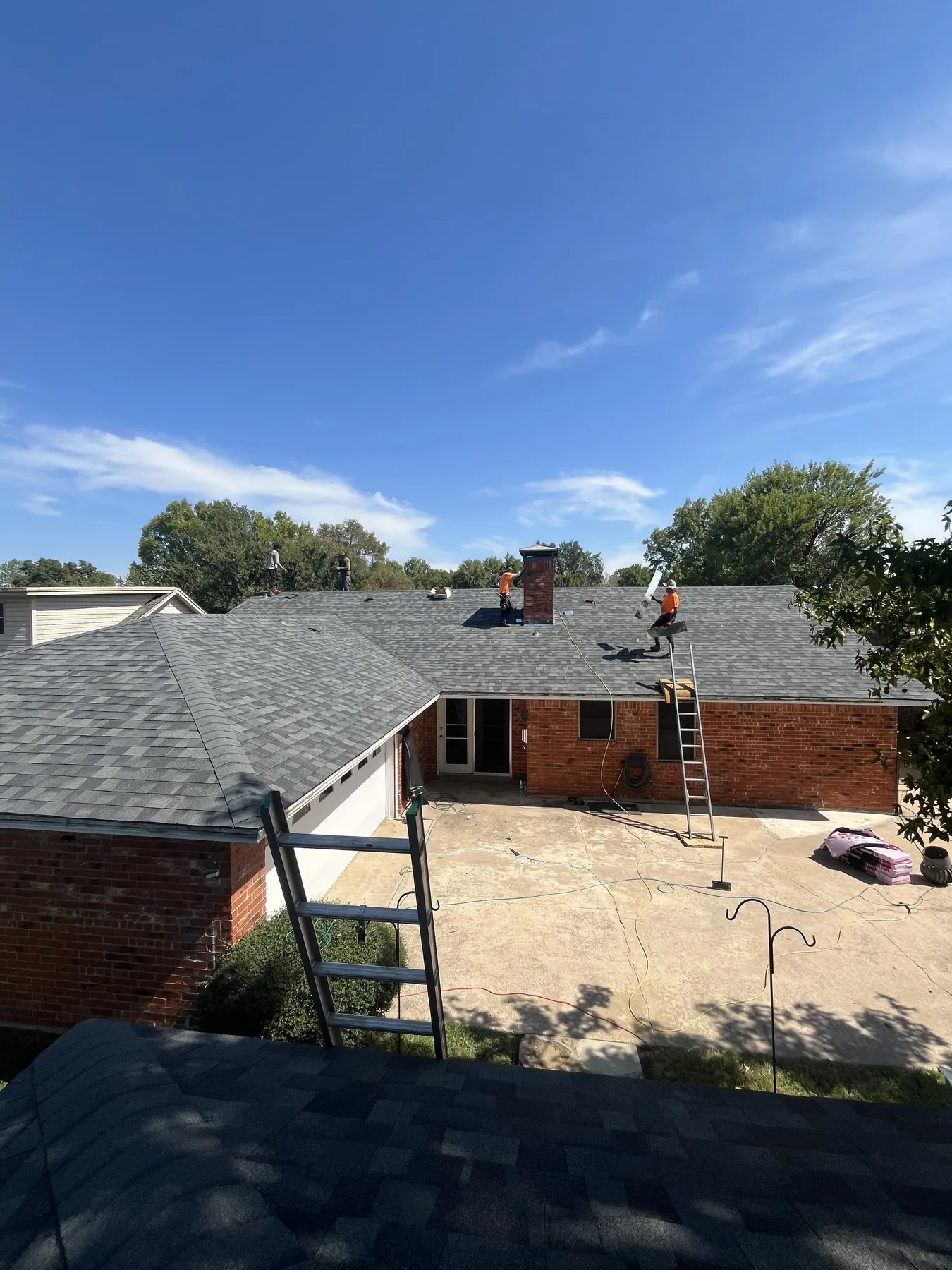 Completed hail-damage roof replacement viewed from the rear in Sherman Texas