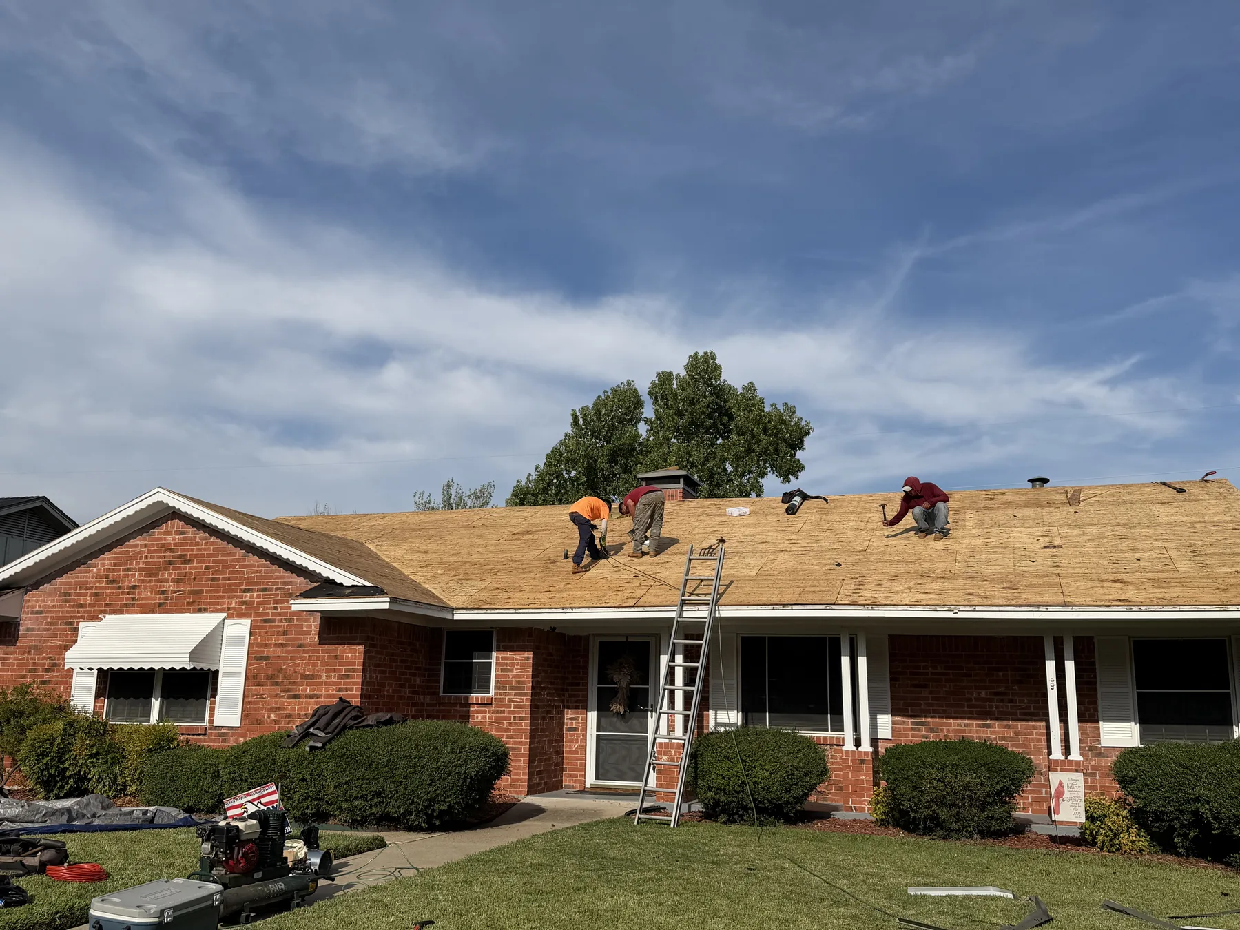Hail-damaged roof tear-off in progress on a Sherman Texas home