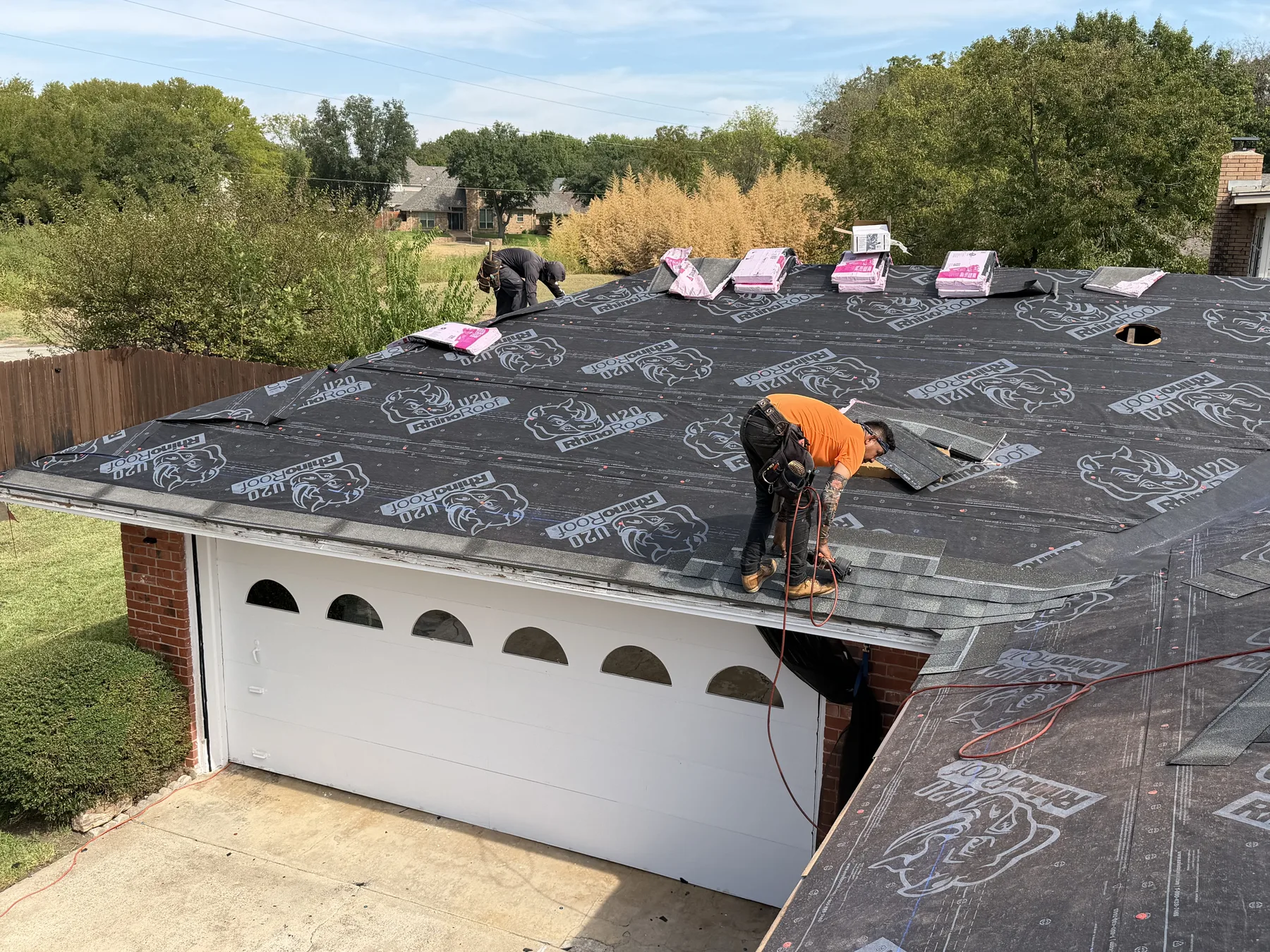 Synthetic roof underlayment installation during a Sherman Texas roof replacement