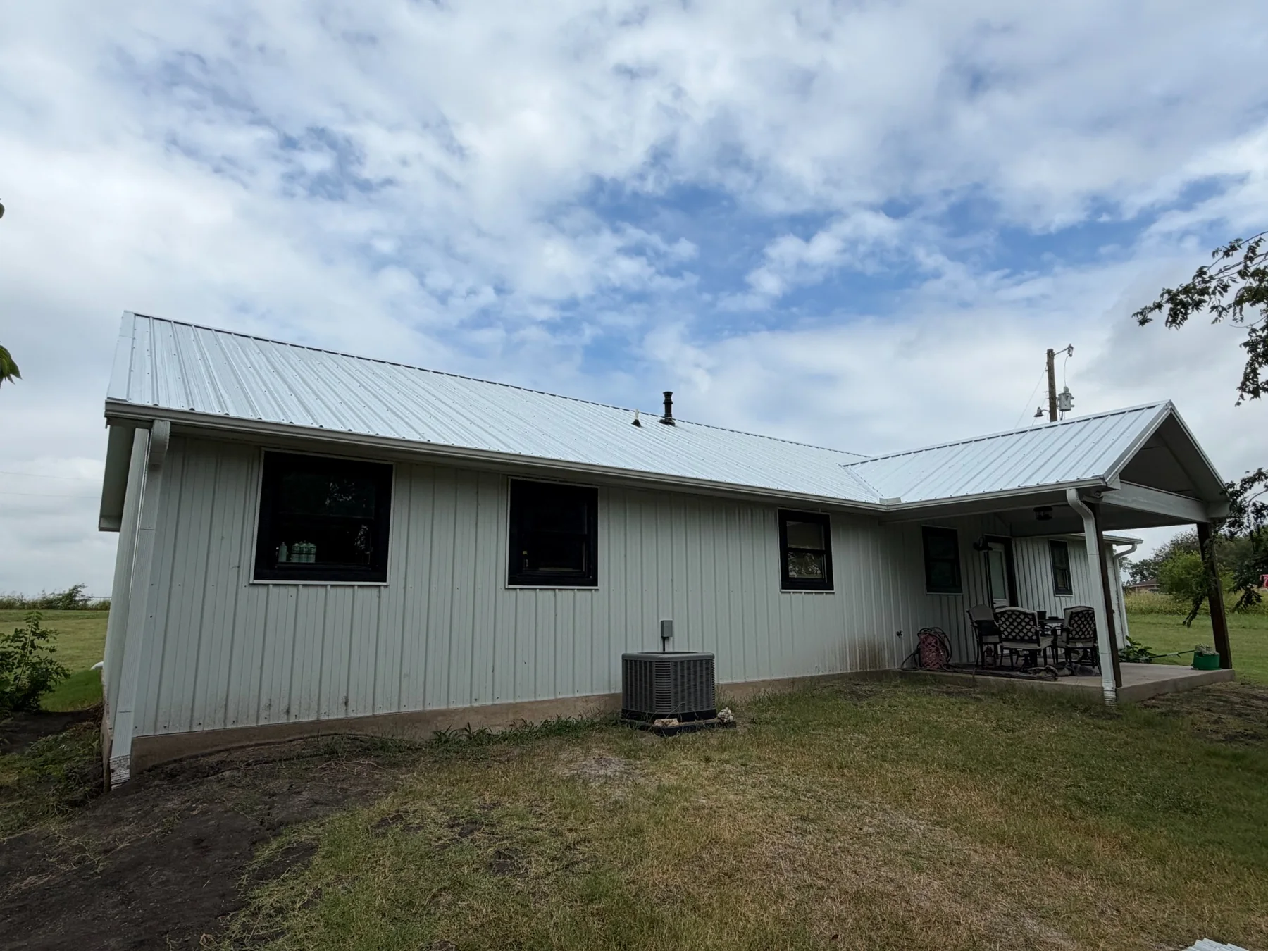 Completed Galvalume metal roof and gutters on a Tom Bean Texas home