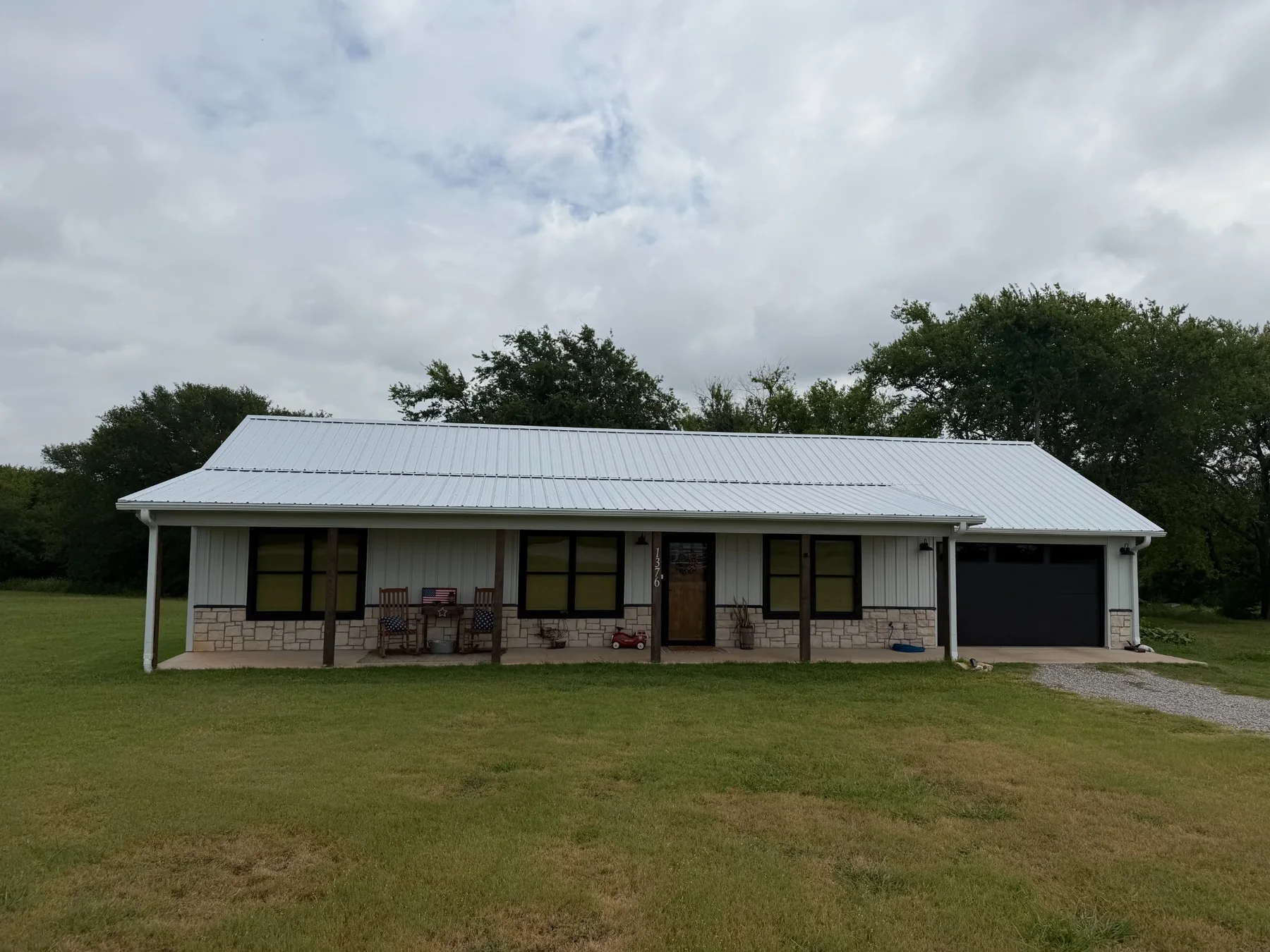 Completed Galvalume metal roof installed by American Roofing & Construction in Tom Bean, Texas